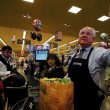 Los Angeles City Councilman Tom LaBonge bags groceries into reusable grocery bags at a Pavilions store.